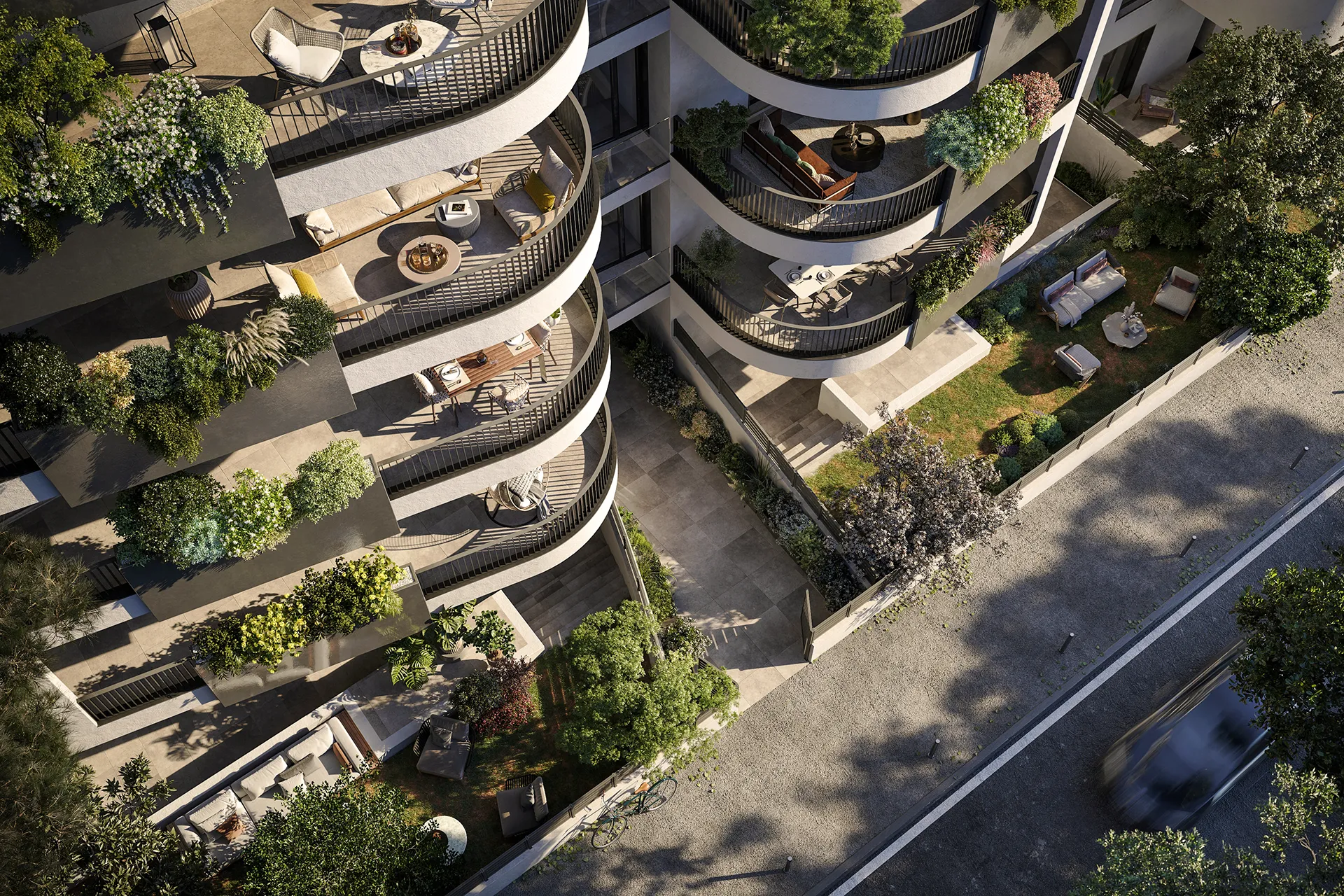 Fonte Laurentina: veduta a volo d'uccello di un moderno edificio residenziale con balconi curvi arredati e terrazze verdi, vicino a una strada con un'auto in movimento.